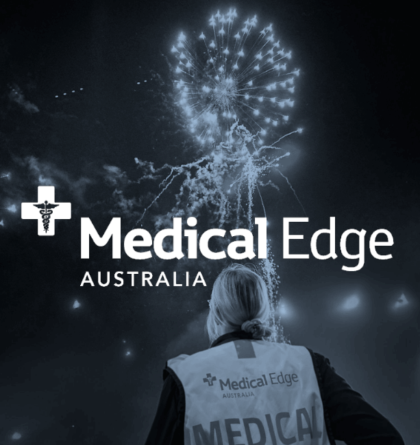 Medical Edge Australia logo superimposed on a photo of a paramedic looking at fireworks.